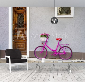 Bild på pink bike standing by the wall